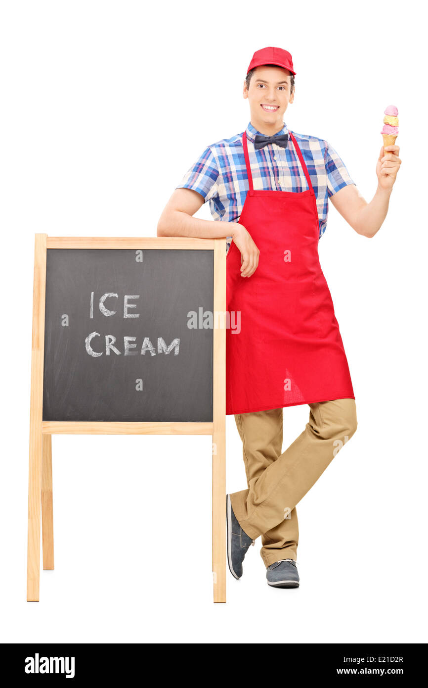 Full length portrait of an ice cream vendor standing by a blackboard