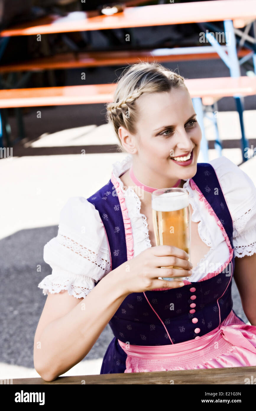 Bavarian woman in the beer garden Stock Photo - Alamy