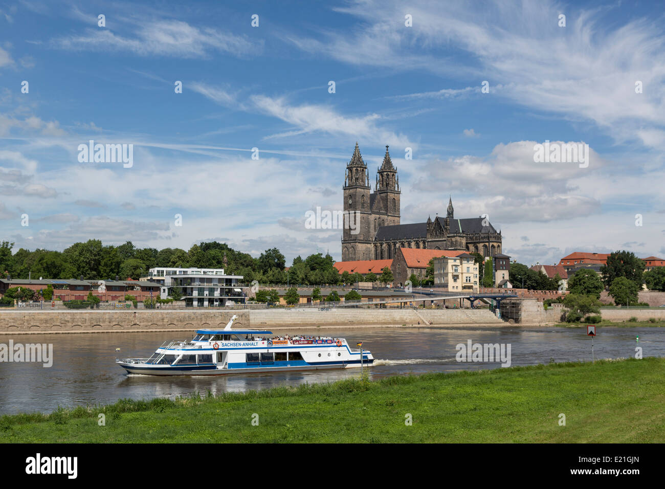 River Elbe with a sightseeing boat and a view on the cathedral of Magdeburg, Germany Stock Photo