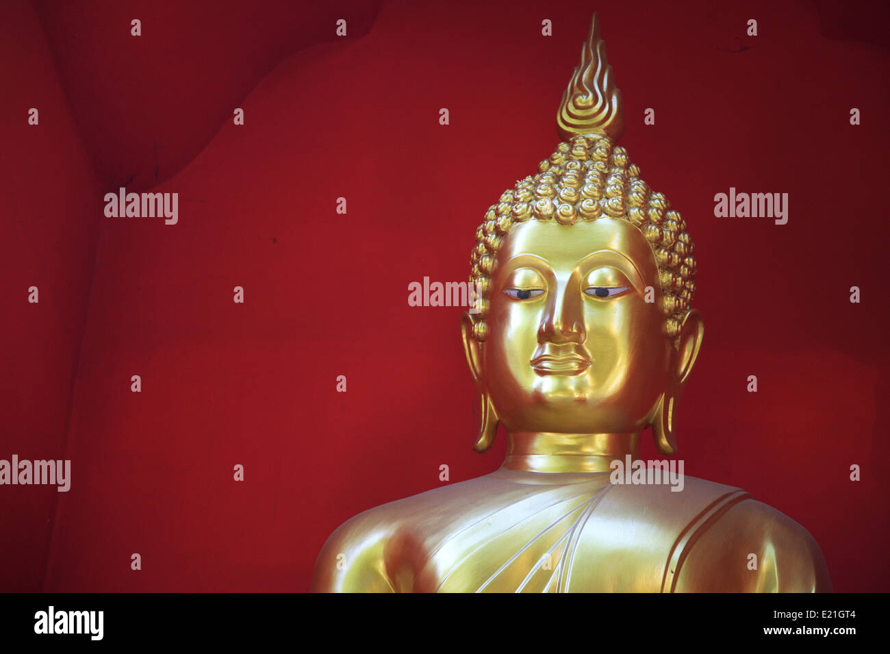 Golden Buddha against a red background Stock Photo - Alamy Golden Buddha against a red background Stock Photo - Alamy
