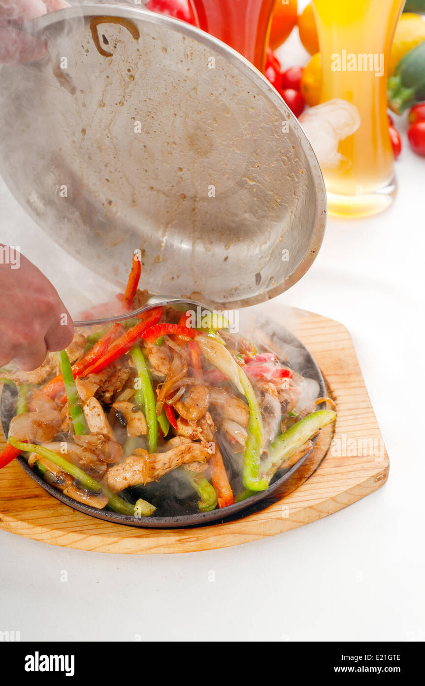 original fajita sizzling hot on iron plate Stock Photo Alamy