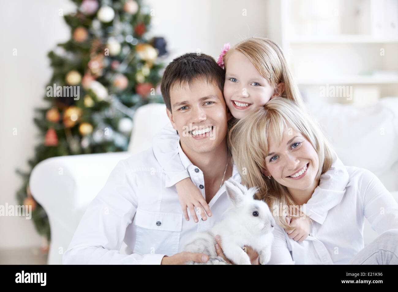 A happy family with a rabbit at home Stock Photo - Alamy