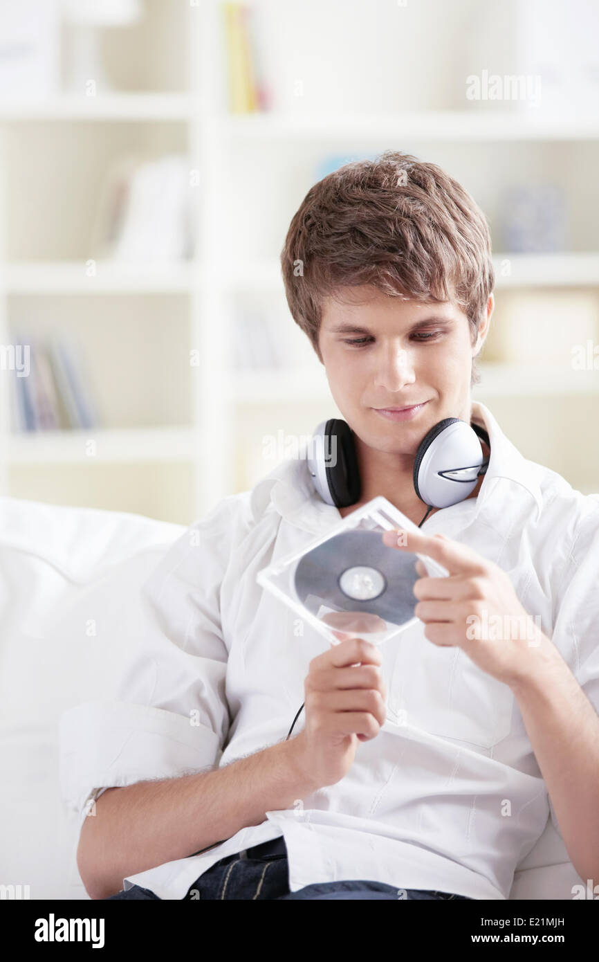 A young man holds a music CD Stock Photo