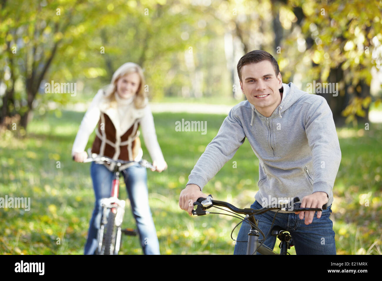 A young man on a bicycle in the foreground Stock Photo