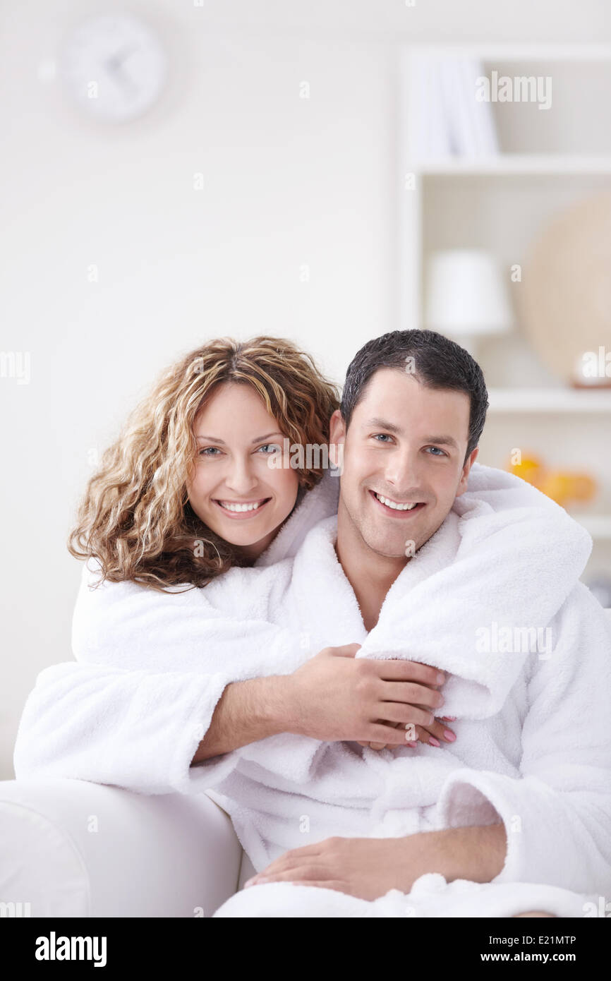 Young couple embracing in robes at home Stock Photo - Alamy