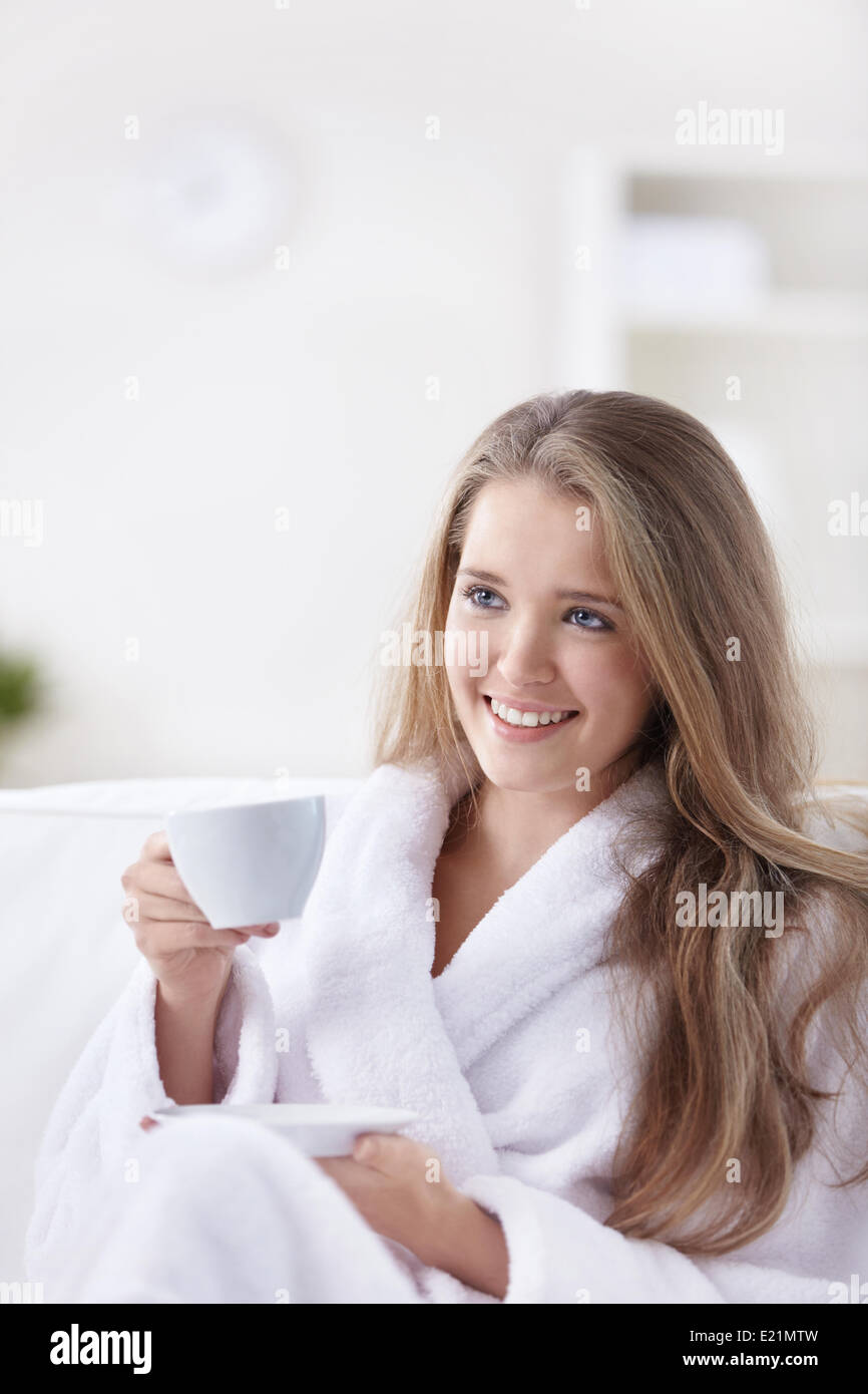 Cute girl in a bathrobe with a cup Stock Photo Alamy