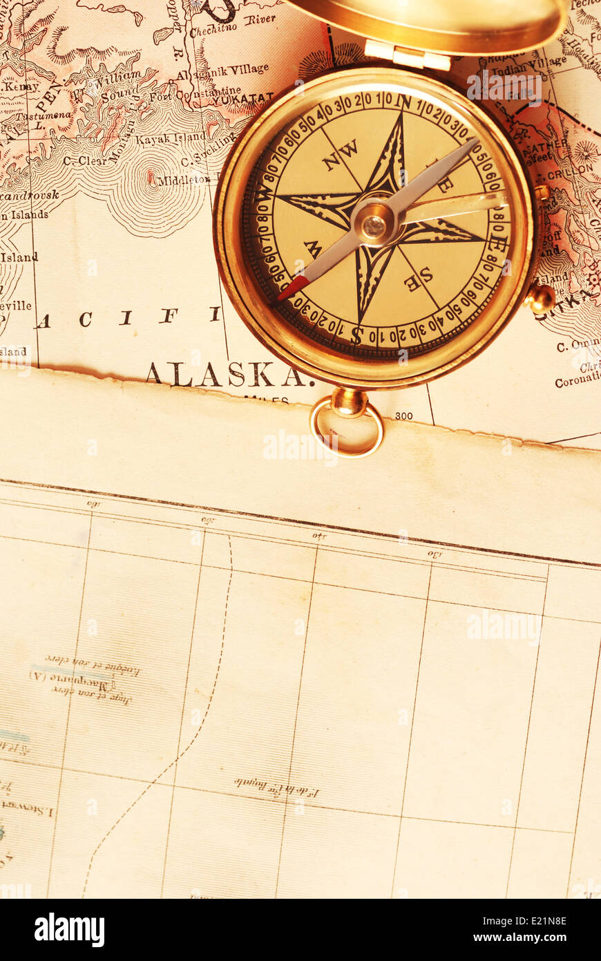 Antique brass compass over old map Stock Photo