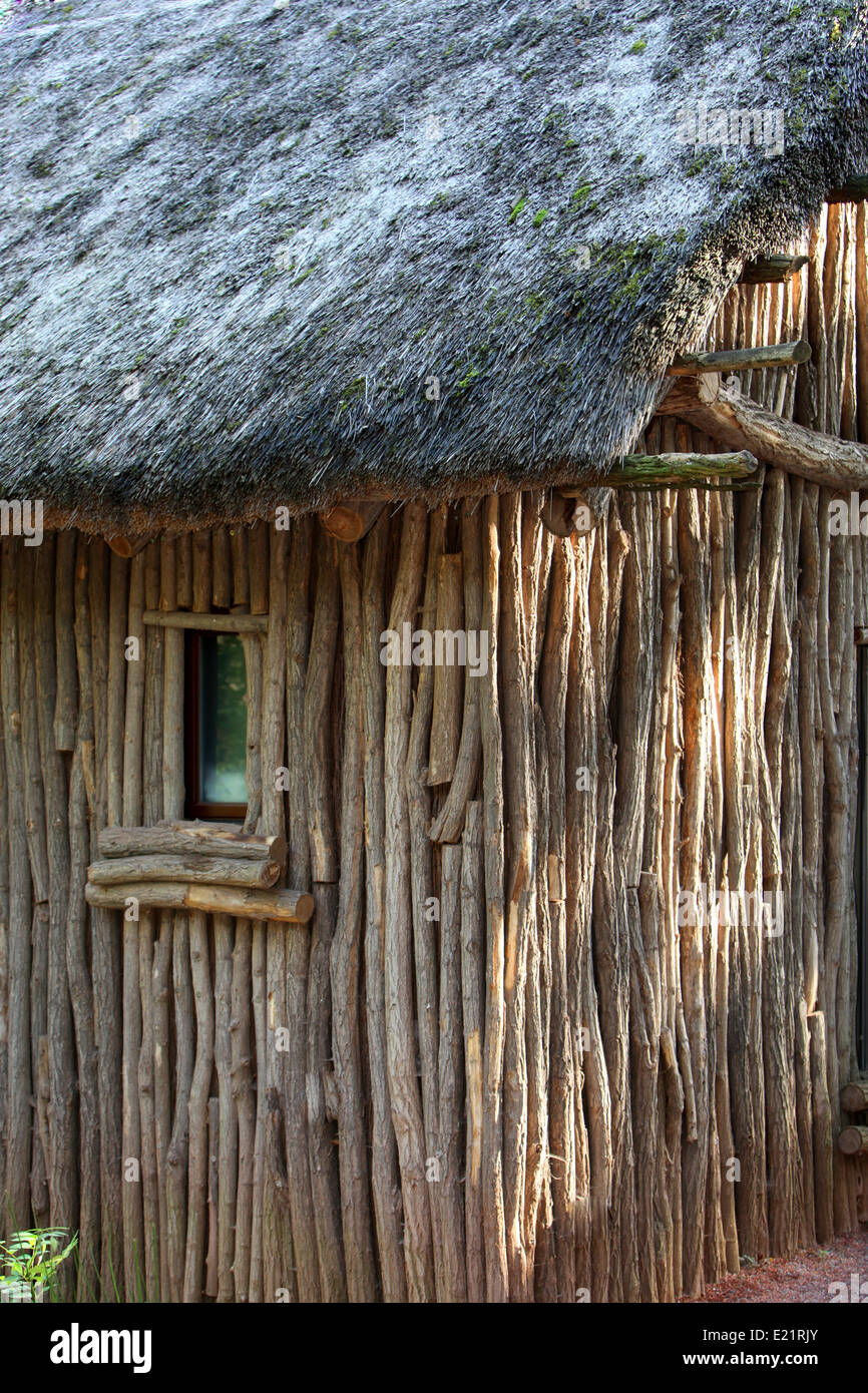 Old wooden lodge with straw roof Stock Photo