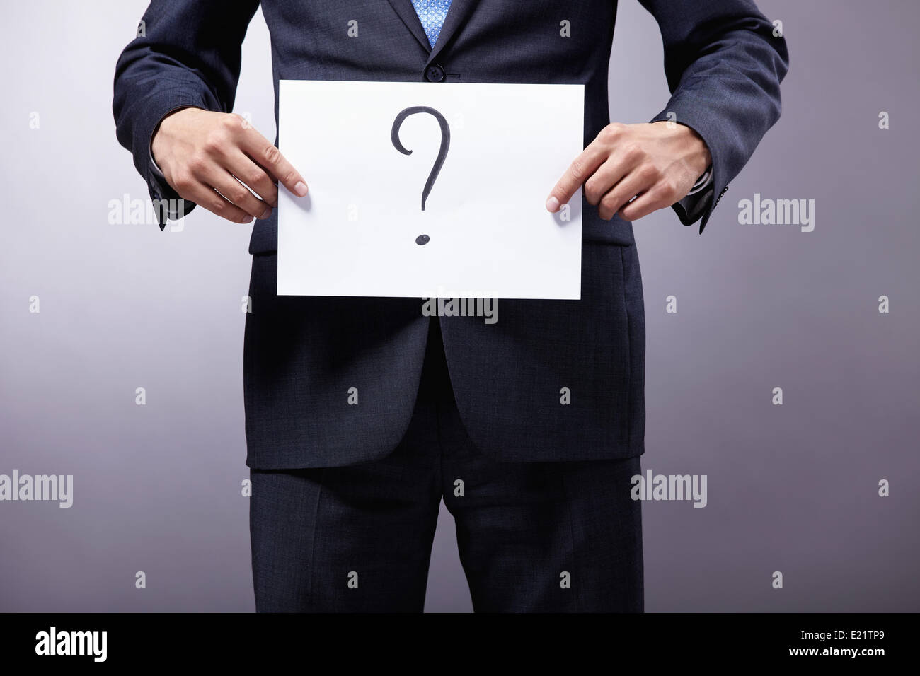 A man holding a sign with a question mark Stock Photo