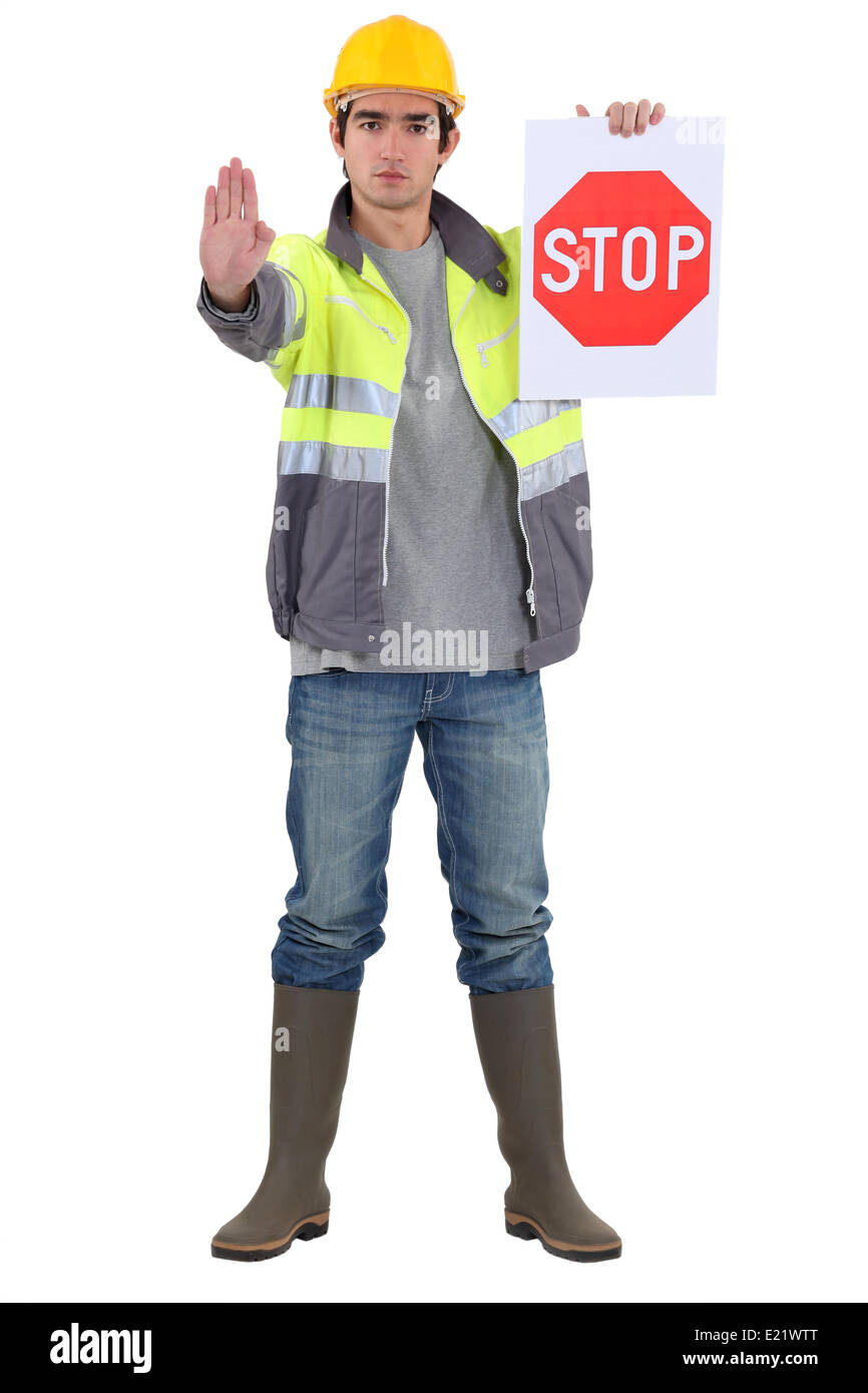 Traffic guard directing traffic Stock Photo