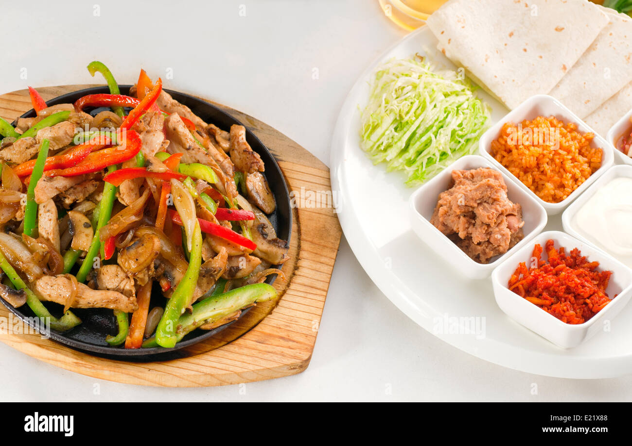 original fajita sizzling hot on iron plate Stock Photo Alamy