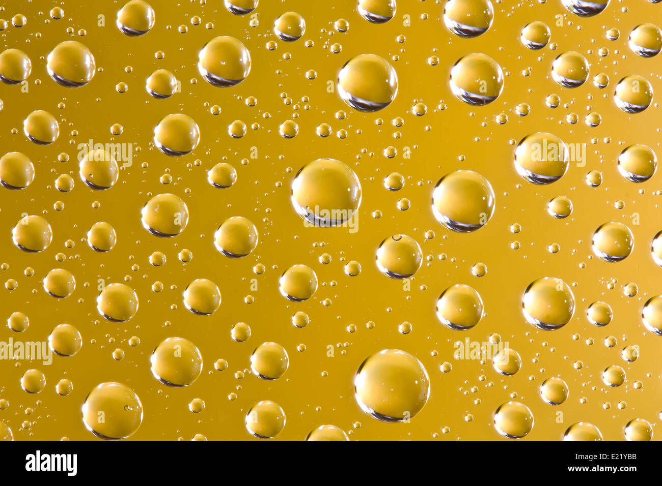 Abstract water drops over yellow background Stock Photo - Alamy