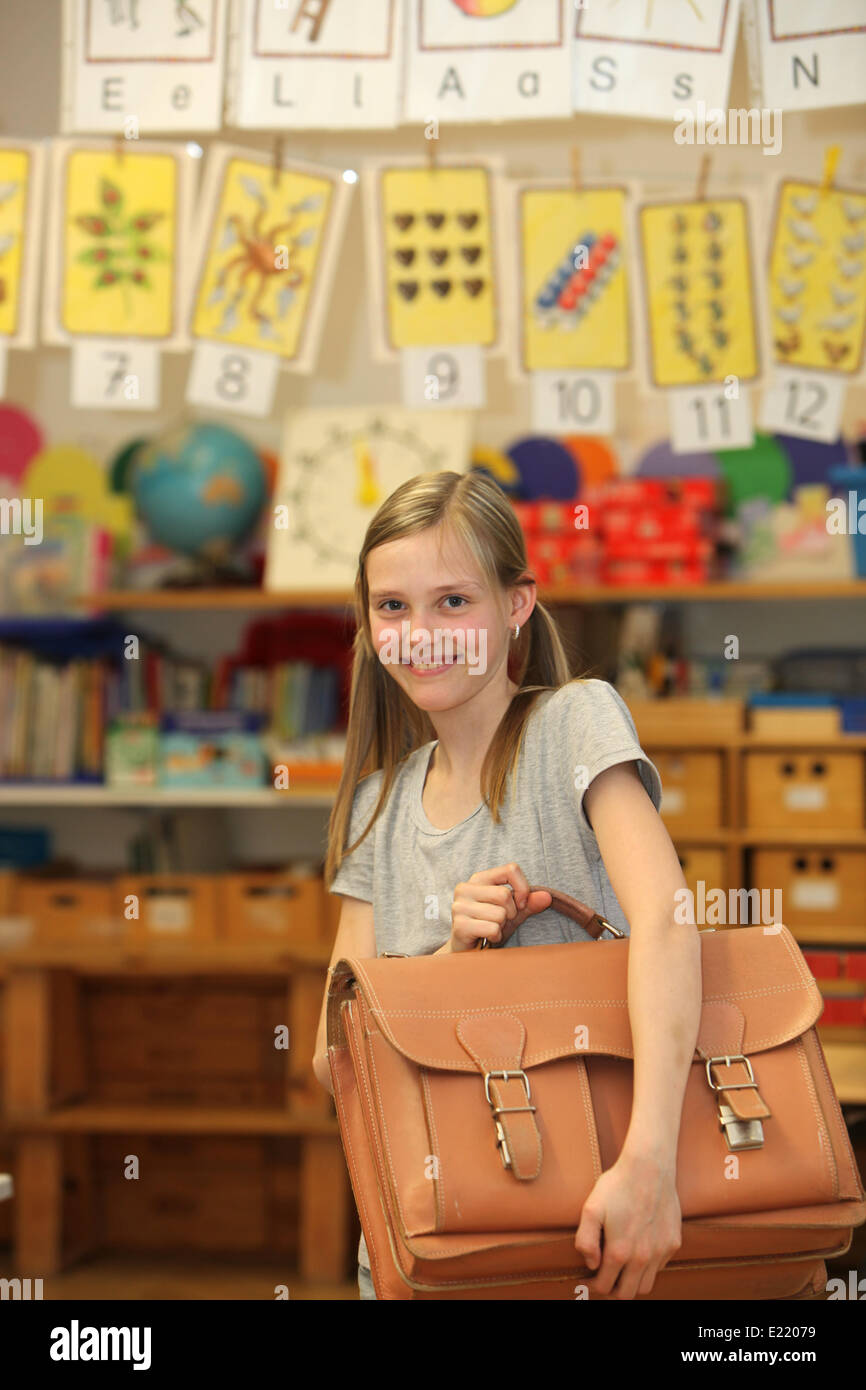 Happy girl at school with school bag Stock Photo - Alamy