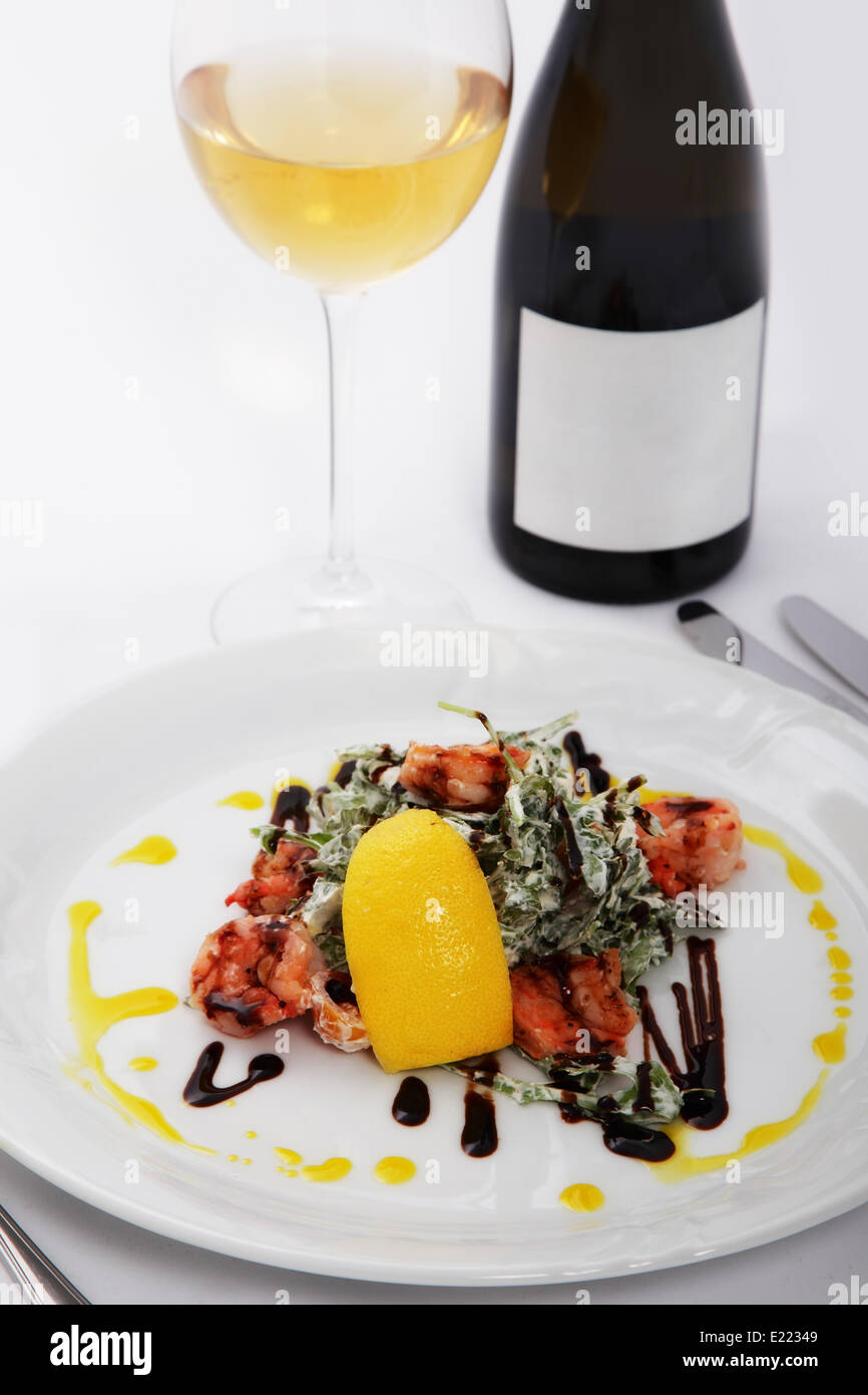 salad with tiger prawns and glass of wine Stock Photo