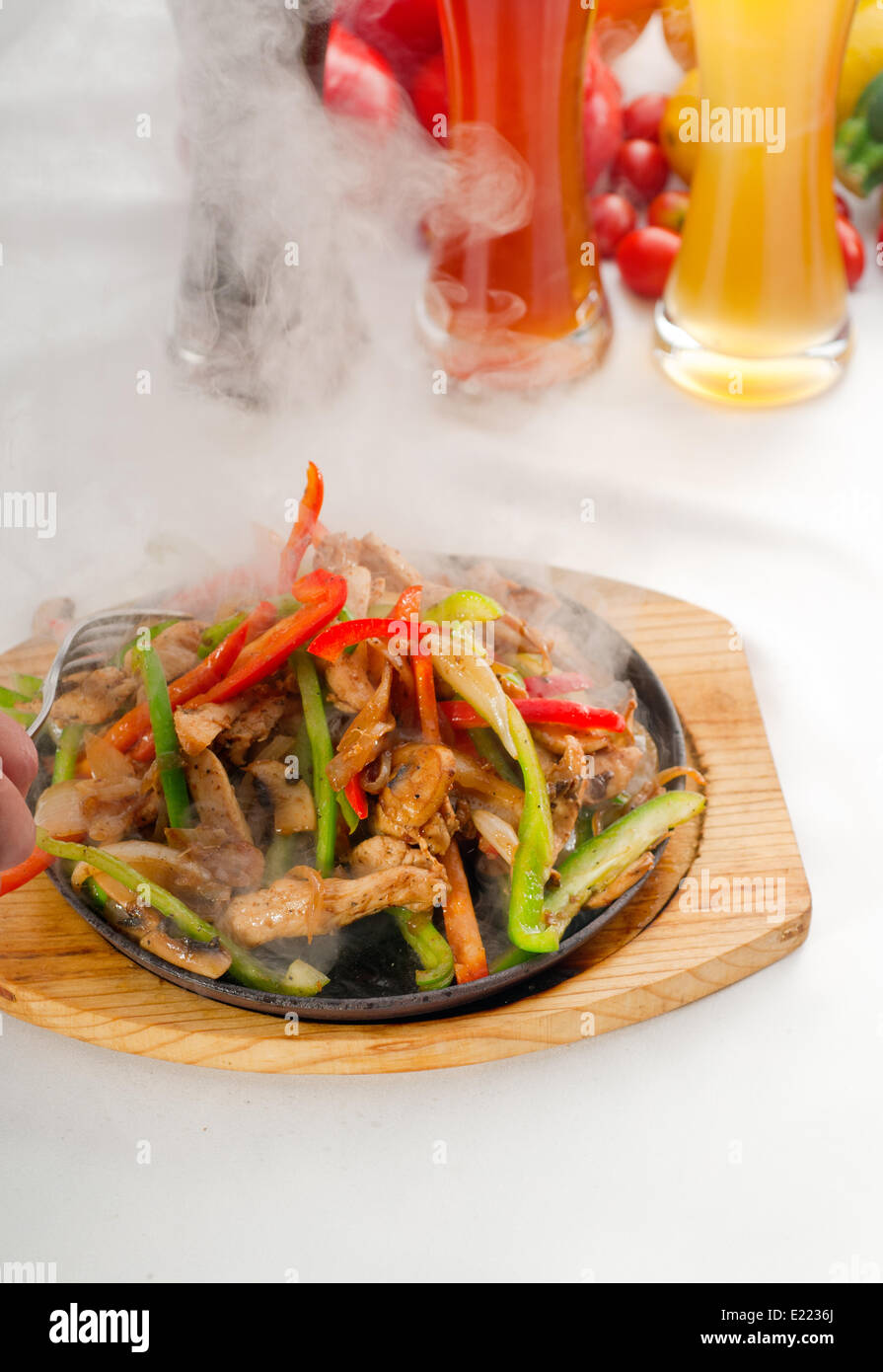 original fajita sizzling hot on iron plate Stock Photo Alamy