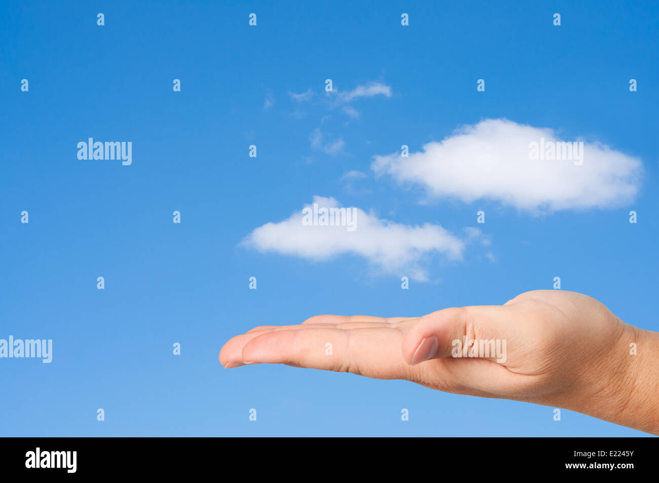 Hand in sky clouds background. Stock Photo