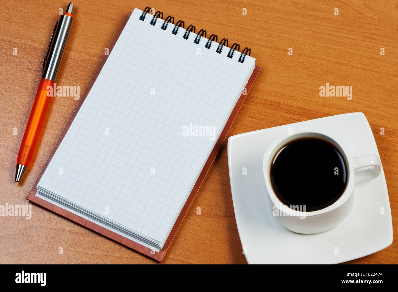 Pen, notebook and coffee on table. Stock Photo