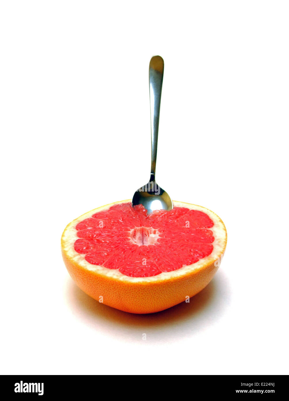 a half grapefruit with a spoon Stock Photo Alamy