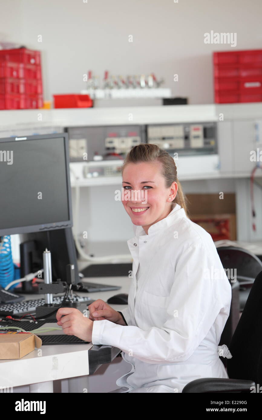 Smiling confident female technician Stock Photo