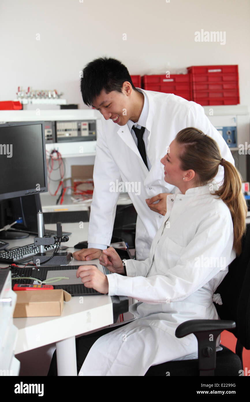 Two lab technicians discussing their work Stock Photo