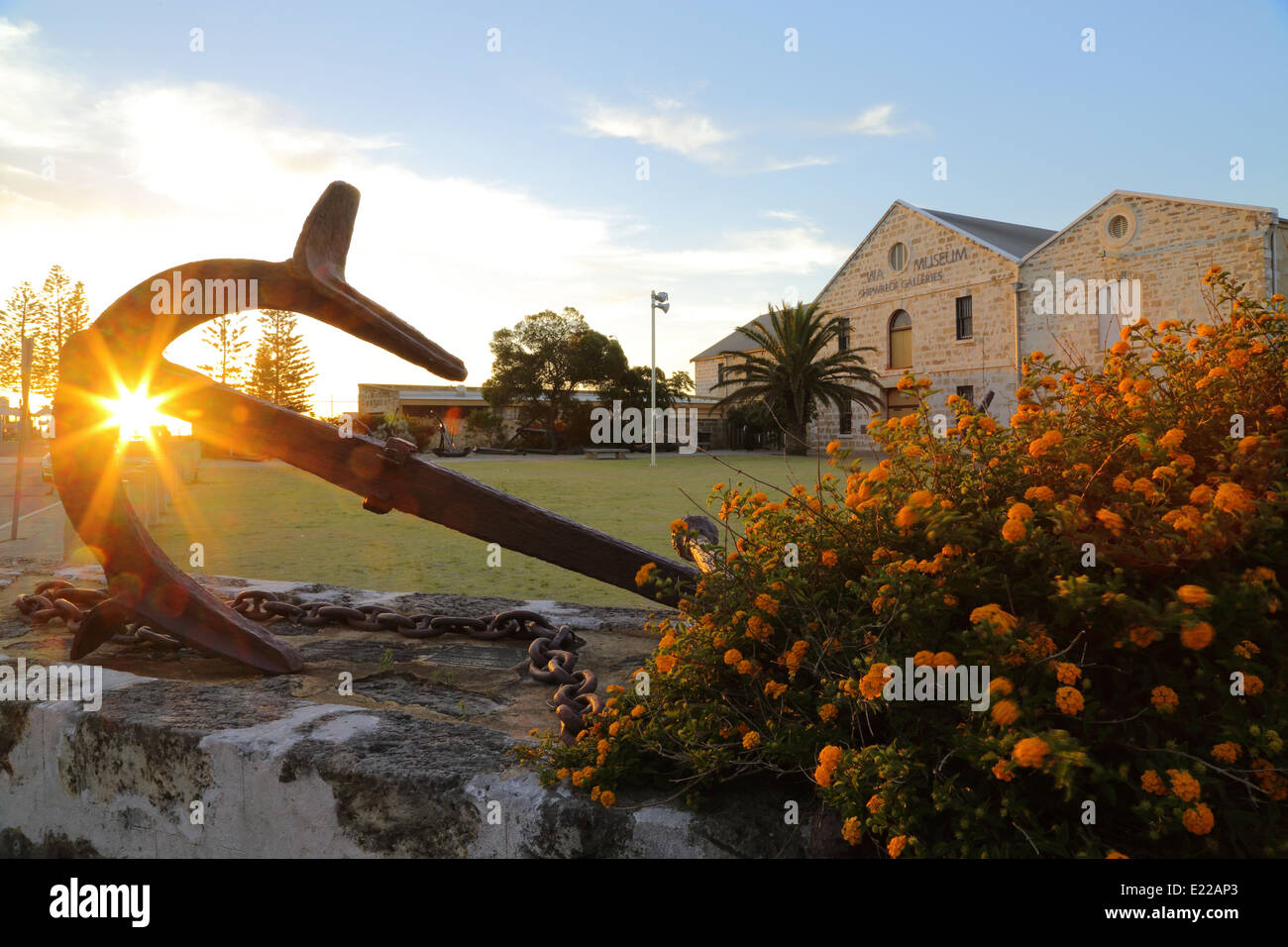 The sun sets behind an anchor at the 'Western Australia Museum - Shipwreck Galleries' in Fremantle. Stock Photo