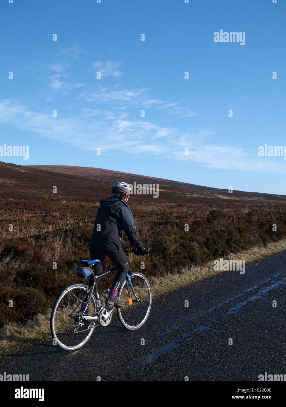Cycling through moorland Stock Photo