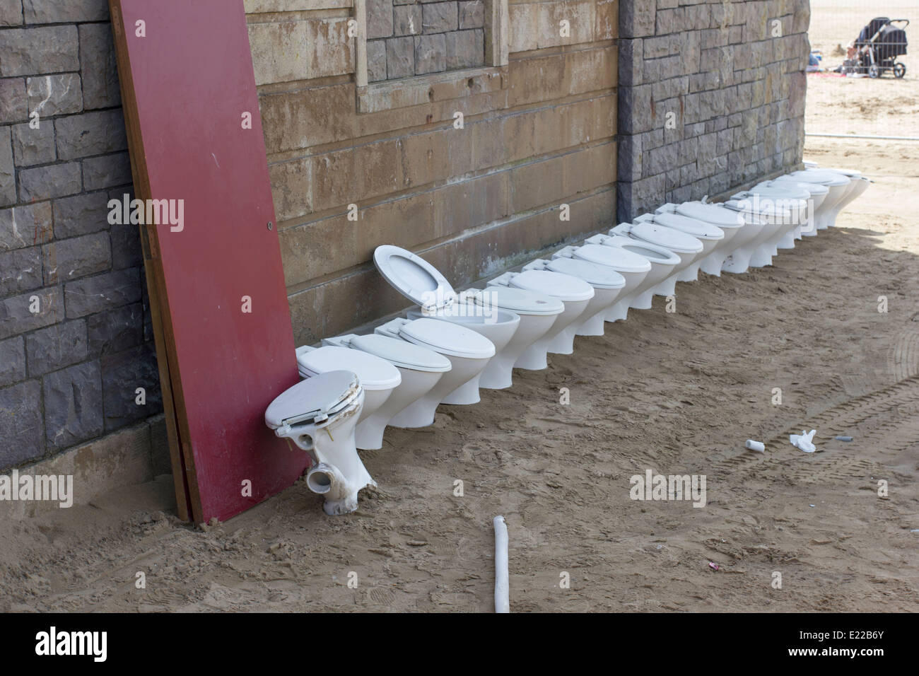 A row of toilets removed from a public toilet on the beach in Weston-super-Mare, England, UK Stock Photo