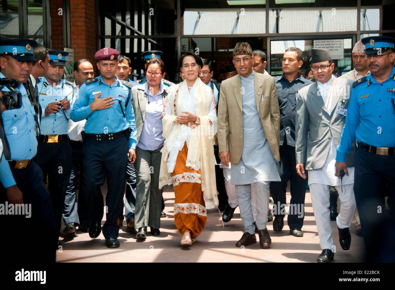 Kathmandu, Nepal. 13th June, 2014. Myanmar opposition leader Aung San Suu Kyi (C) arrives at Kathmandu's Tribhuvan International Airport (TIA) in Kathmandu, Nepal, June 13, 2014. Myanmar opposition leader Aung San Suu Kyi arrived in Nepal Friday for a four-day visit, officials here confirmed. Credit:  Pratap Thapa/Xinhua/Alamy Live News Stock Photo