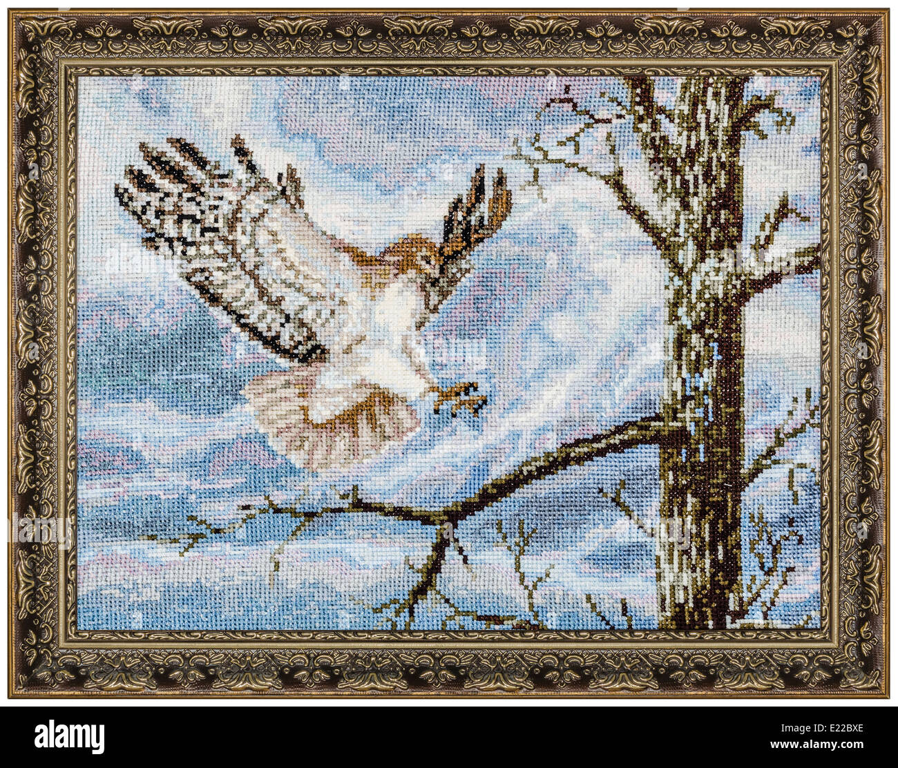 Embroidered picture in the frame, isolated on white background Stock