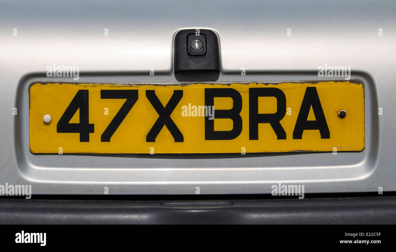 Image of car number plate digitally altered by switching number 47 date letter X around to indicate large brassiere size studio Stock Photo