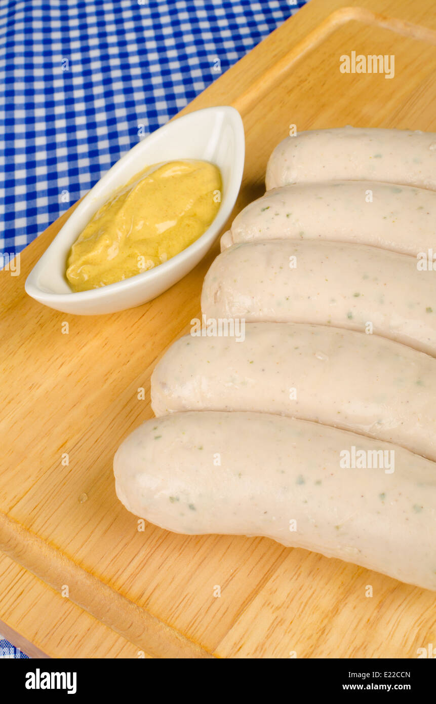 Raw German Bratwurst sausages with some mustard Stock Photo