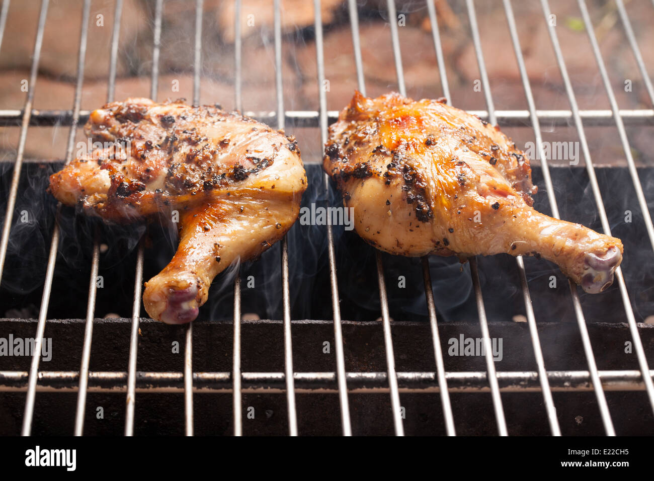Roasting chicken with smoke from stove Stock Photo Alamy