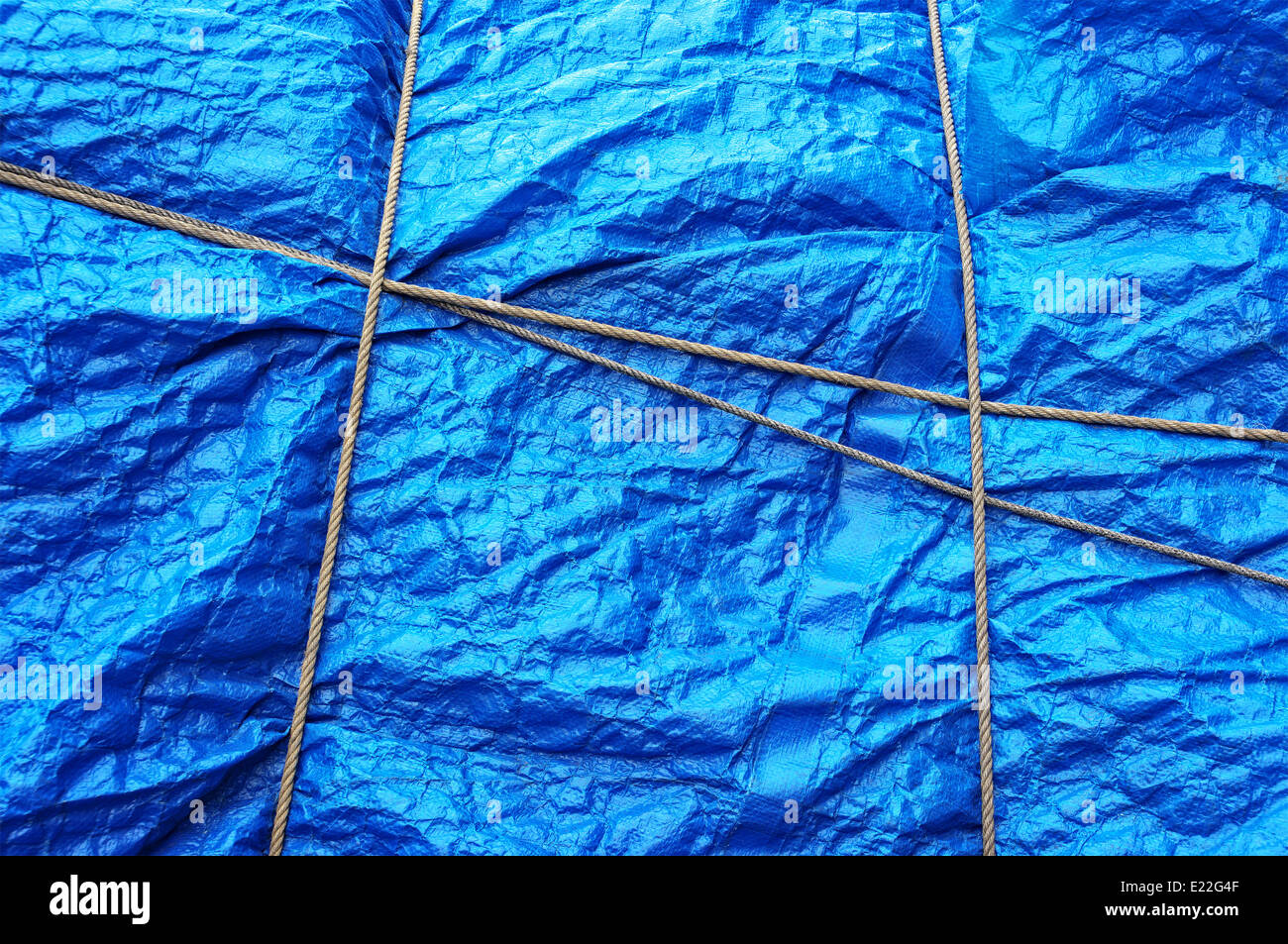 texture of plastic waterproof tarpaulin with rope Stock Photo