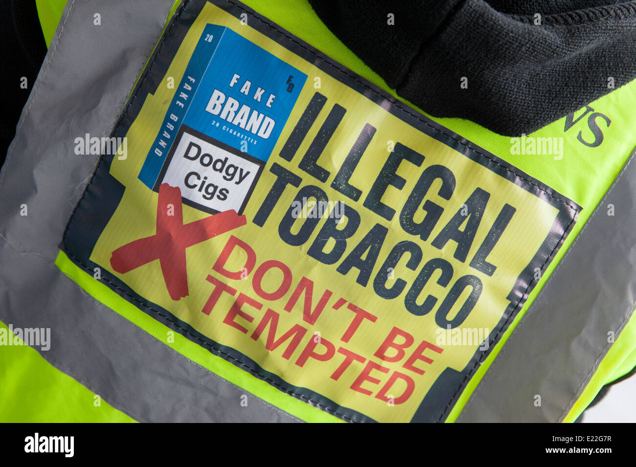 Fake Brand, Dodgy Cigs, Illegal tobacco hi-vis shirt, Don't be tempted, Jacket being worn in Manchester, UK Stock Photo