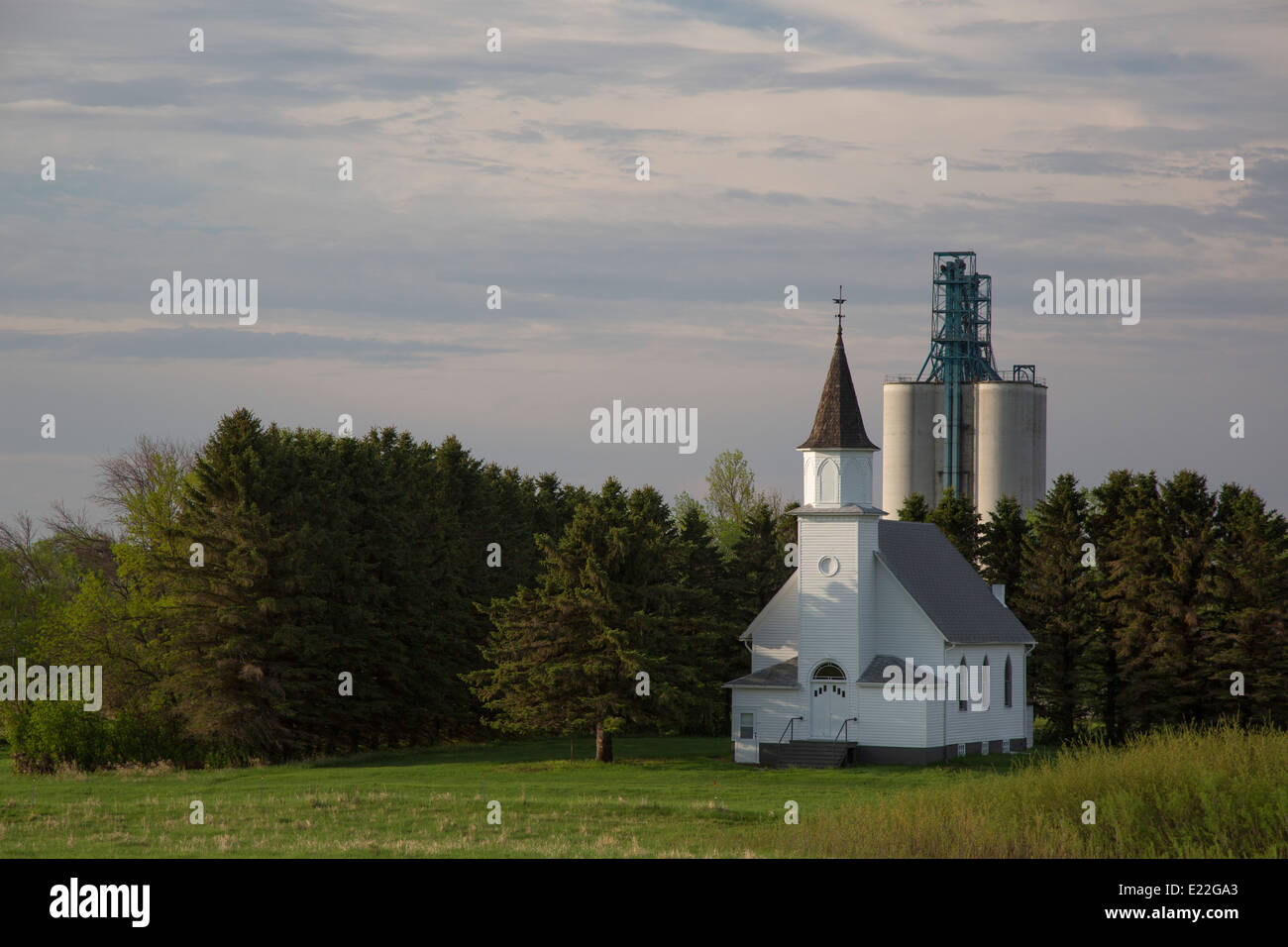 Maddock, North Dakota - A rural church and a grain elevator. Stock Photo