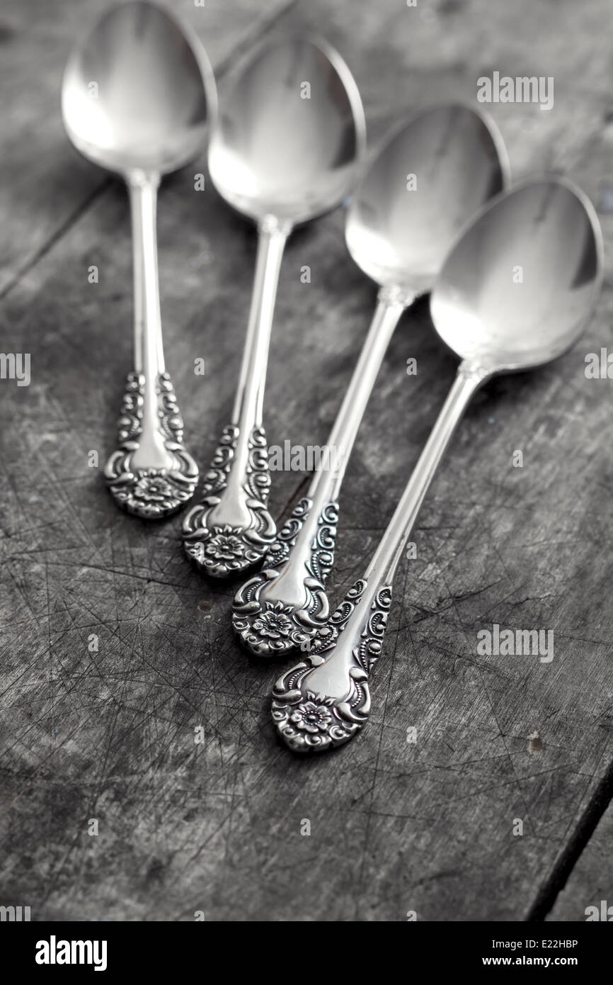 old silver spoons on wooden table, close up Stock Photo
