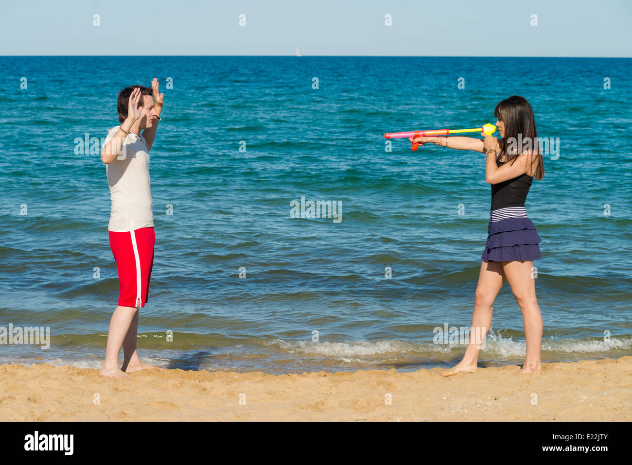 Guy throwing hands up at a squirt gun holdup Stock Photo