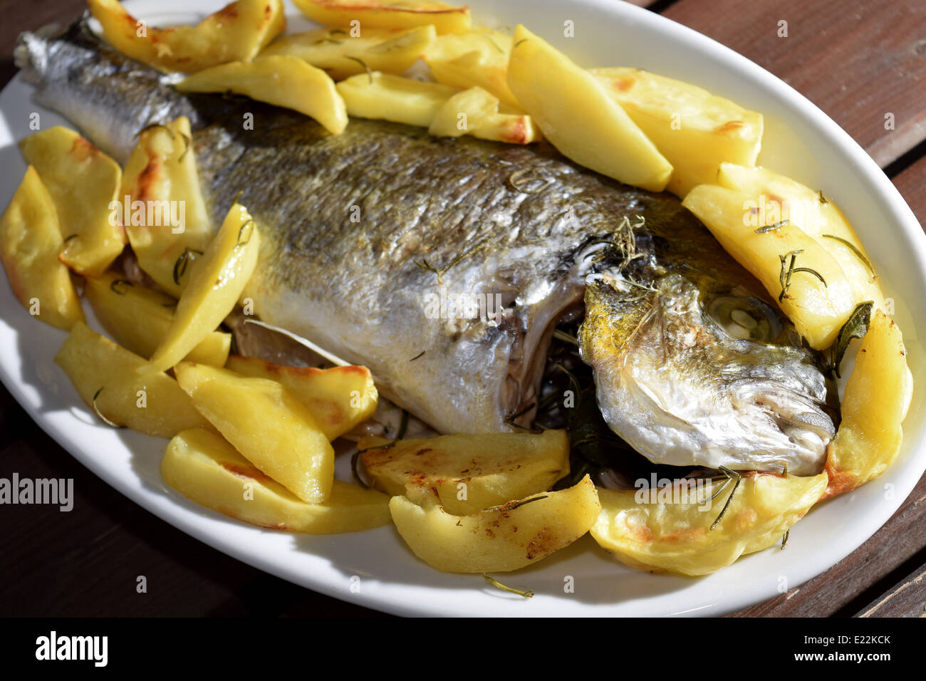 traditinal Italian sea dish: baked sea bream with potatoes Stock Photo