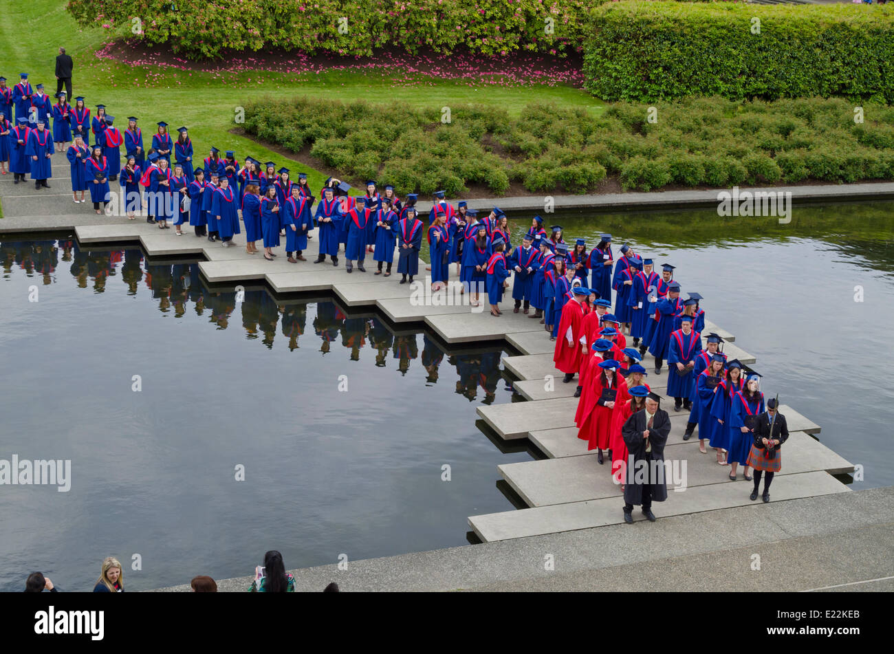 Simon Fraser University  graduands by the reflecting pond in the Academic Quadrangle before the Spring 2014 convocation ceremony for the Faculty of Arts and Social Sciences.  Credit: Maria Janicki/Alamy Stock Photo