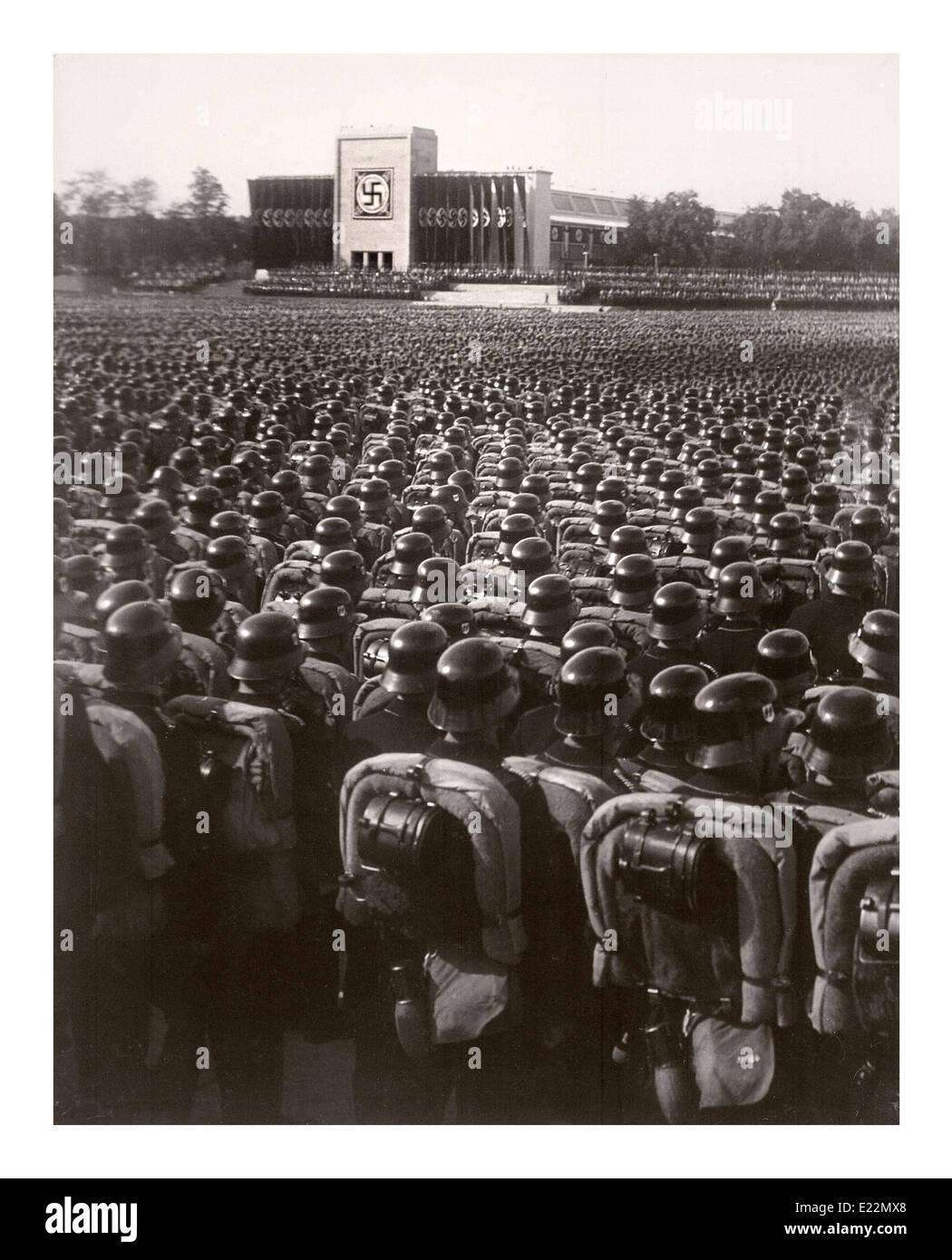 Nuremberg 1930's Waffen SS troops wearing polished helmets in precise serried ranks standing at salute during a German Nazi rally pre-World War 2 Stock Photo