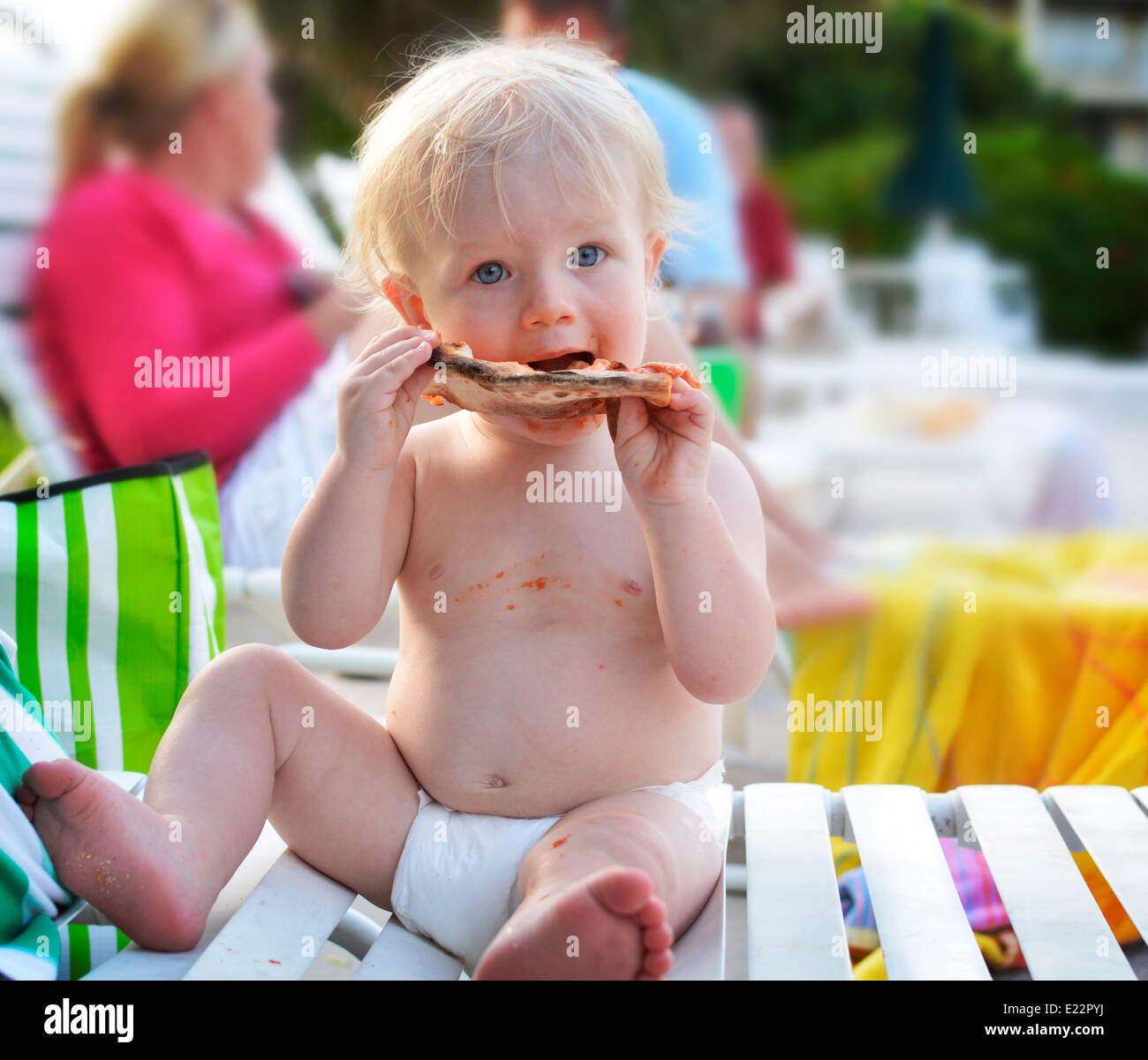 Baby boy eating pizza Stock Photo