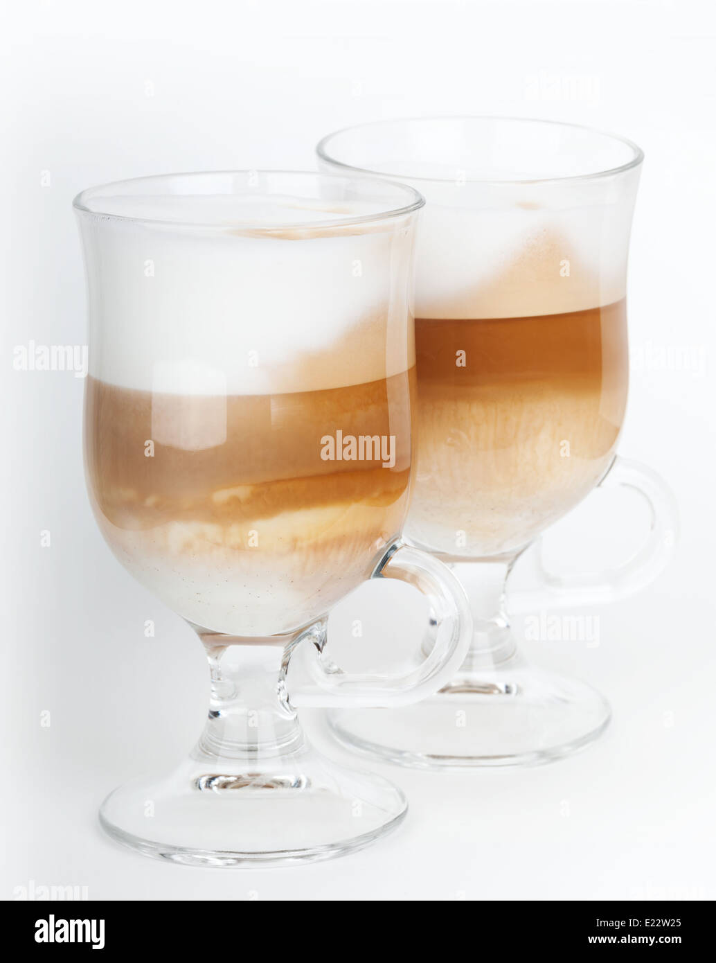 https://c8.alamy.com/comp/E22W25/two-glass-mugs-with-handles-of-latte-coffee-macro-photo-E22W25.jpg