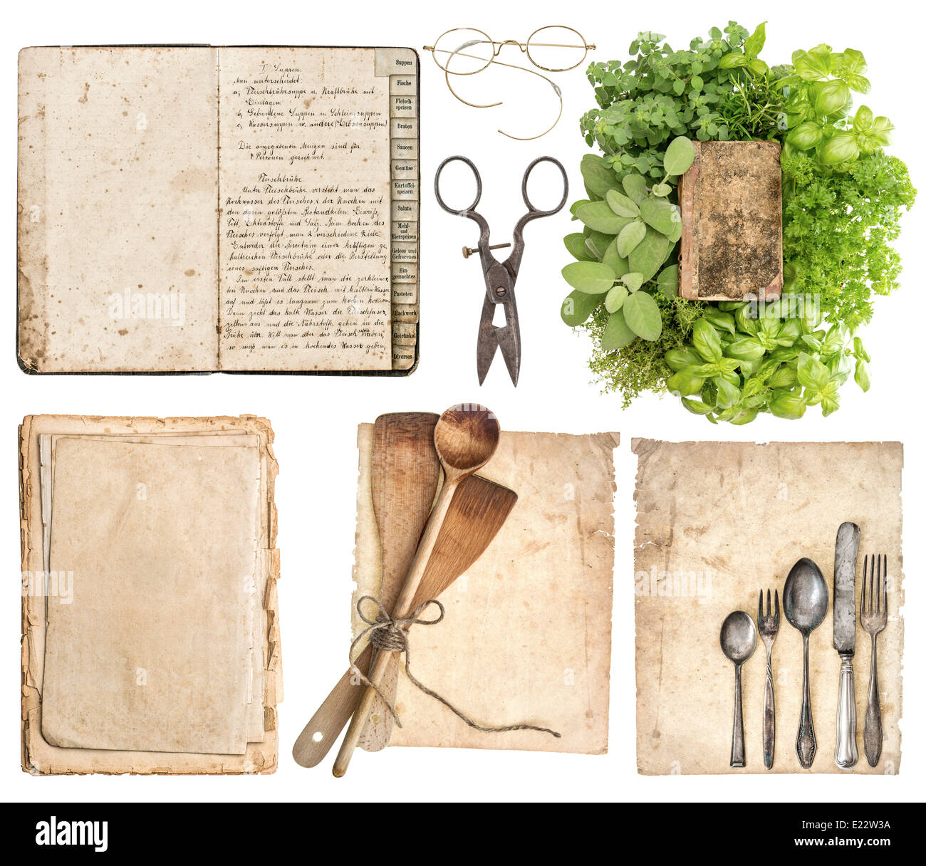 Old wooden kitchen utensils, antique cookbook, aged paper pages and herbs isolated on white background. Stock Photo