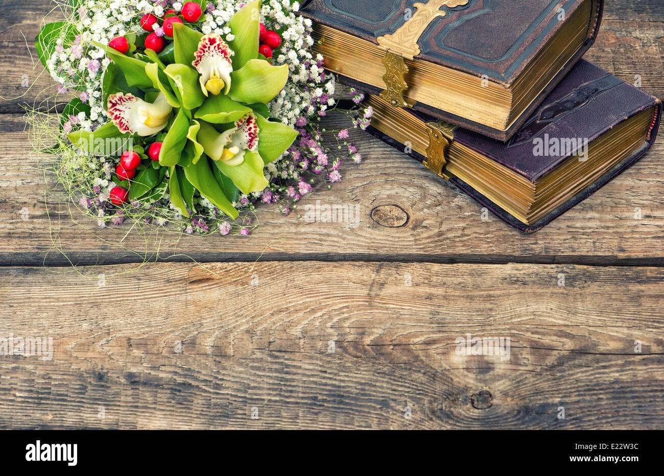 old books and orchid flowers over rustic wooden background. nostalgic ...