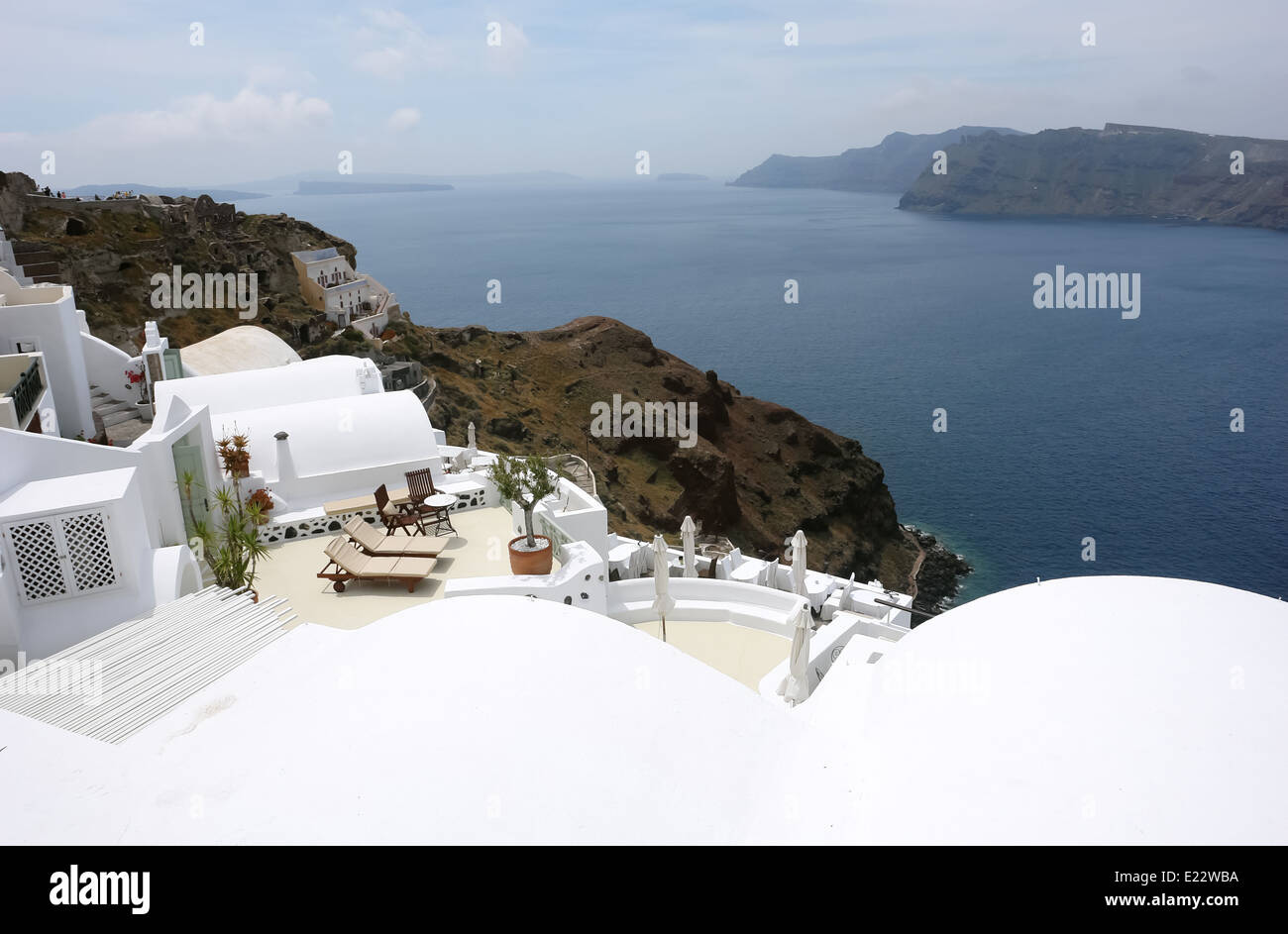Terrace with lounges and sea on Santorini Island in Greece. Stock Photo