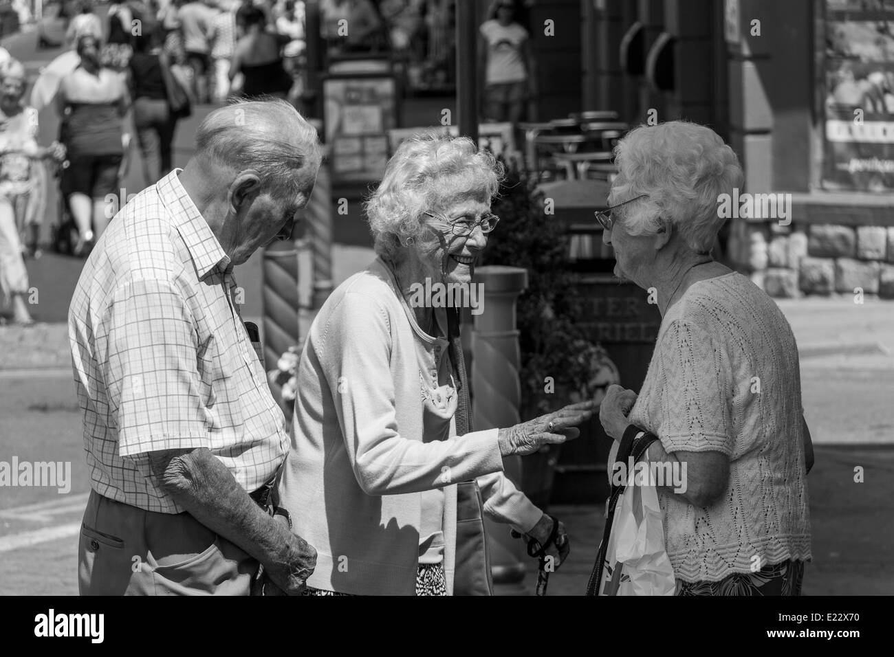 As I was saying only yesterday. We have got to stop talking and go home. Old friends in Porthcawl town South Wales Stock Photo