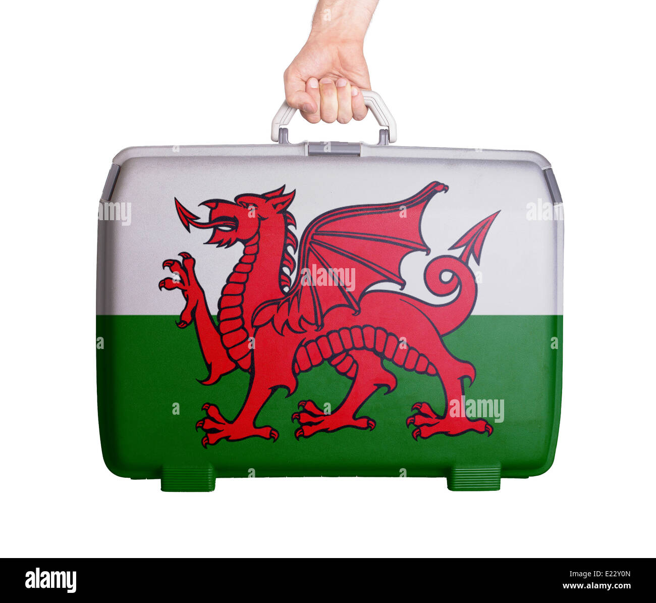 Used plastic suitcase with stains and scratches, printed with flag, Wales Stock Photo