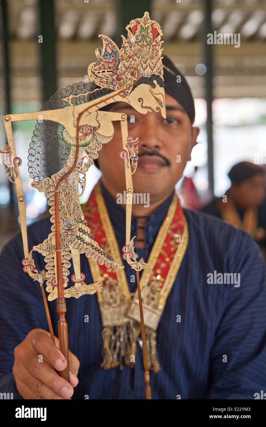 Master craftsman inspects the traditional leather puppet before the