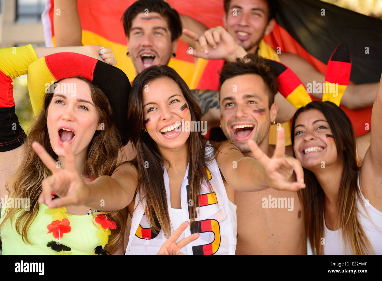 Group of enthusiastic German sport soccer fans celebrating victory