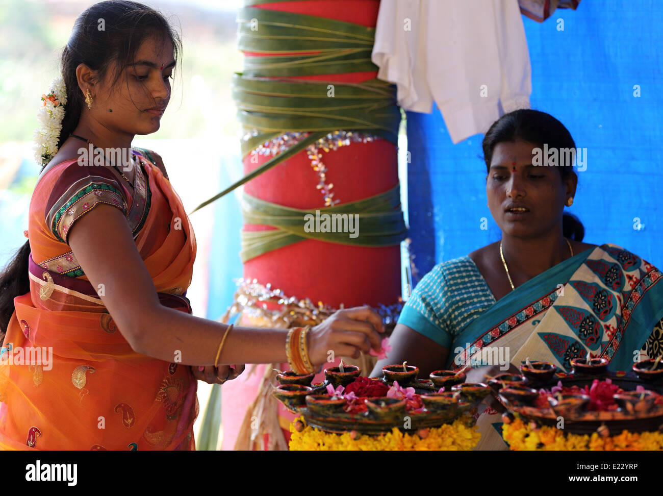 Indian women offering flowers for a Hindu ceremony India Stock Photo